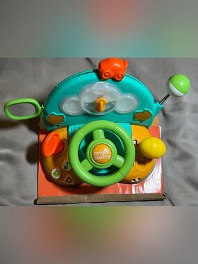 activity steering wheel in green and teal. Engaging buttons, spinning wheel 6+M